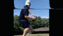 a man wearing a white hat is holding a football in his hands