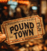 person holding a ticket that says pound town