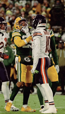 a football player with the number 10 on his back talks to another player