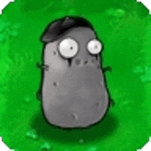 a cartoon potato wearing a hat is standing on a green field .