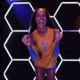 a woman wearing a yellow jersey with the number 5