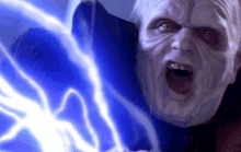 a close up of a man 's face with a blue lightning bolt coming out of his mouth .