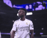 a soccer player wearing a emirates fly better shirt