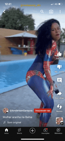 a woman in a spiderman costume is dancing on a phone screen