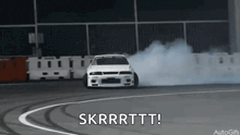 a white car is drifting on a race track with the words skrrrttt written below it
