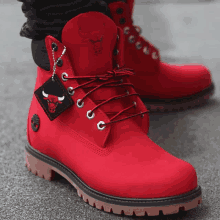 a pair of red timberland boots with a chicago bulls tag