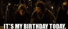 two men are standing next to each other in a dark room and they are saying it 's my birthday today .