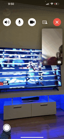 a phone screen shows a video of a boxing match with the time of 9:50