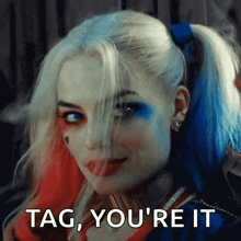 harley quinn says tag you 're it while sticking her tongue out