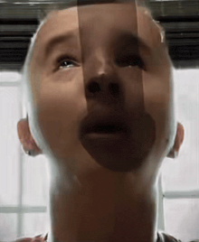 a close up of a person 's face with a shadow on it