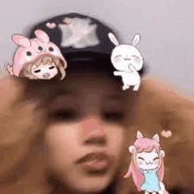 a girl wearing a hat with a bunny on it and a bunny on her head .