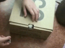 a person is opening a cardboard box that has the number 3 on it