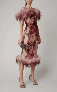 a woman is wearing a dress with feathers on it