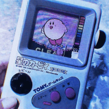 a tomy video game with a kirby on the screen