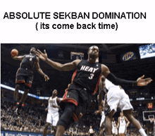 a basketball player wearing a heat jersey jumps in the air