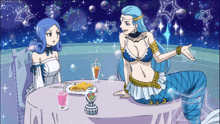 two mermaids are sitting at a table with a plate of food