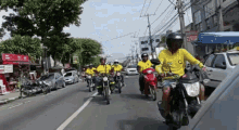 a group of people are riding motorcycles down a street in front of a sign that says ' atacado '