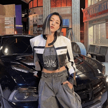 a woman stands in front of a black car in front of a crazy store sign