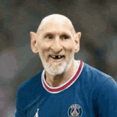 a bald man with a beard and a blue shirt is wearing a soccer jersey .