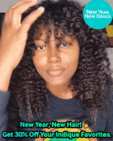 a woman with curly hair is wearing a blue shirt that says new year new hair