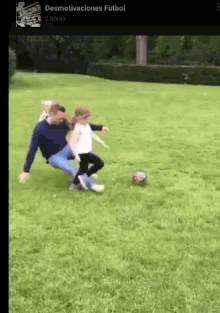 a man and a little girl are playing soccer on a field with the words " desmotivaciones futbol " on the bottom