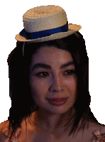 a woman is wearing a straw hat with a blue ribbon