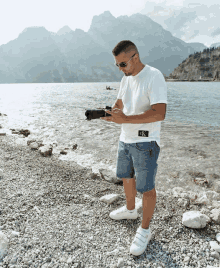 a man wearing a white t-shirt with a calvin klein logo on it