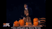 a man in an apron stands in front of pumpkins and says " y'know nothing quite says america like food "