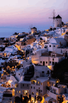 a purple sky is behind a cluster of white houses