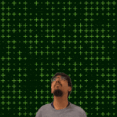 a man stands in front of a green background with the number 21