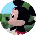 a close up of mickey mouse in a circle with a green background .