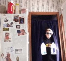 a boy is holding two bottles of milk in front of a refrigerator which has a picture of an american flag on it