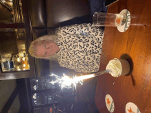 a woman is sitting at a table with a heineken coaster