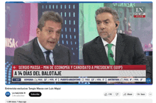 two men are talking on a news channel with the headline sergio massa min de economia y candidato a presidente ( uxp )