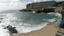 a beach with a building in the background and the words dual summilux on the bottom right