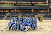 a hockey team poses for a photo in front of the irish stadium