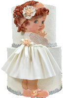 a doll in a white dress with a flower on her head