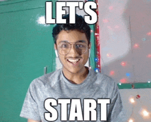 a young man wearing glasses and a grey shirt with the words let 's start written on his face