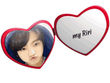 a heart shaped mirror that says my riri on the inside