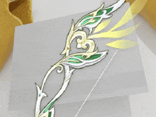 a drawing of a bow and arrow with green and gold leaves