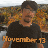a man wearing a black shirt that says november 13 on it