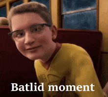 a boy wearing glasses and a yellow shirt with the word batlid moment on the bottom