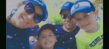 a family posing for a picture wearing blue hats and sunglasses