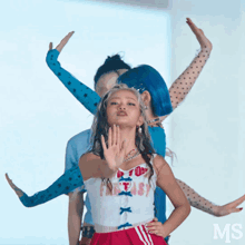 a woman in a white top that says fantasy is dancing with another woman
