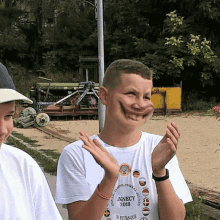 a boy wearing a shirt that says annecy 2018 making a funny face