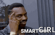 a man has his finger on his forehead in front of a smart girl logo