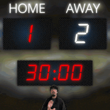 a scoreboard shows that the home team is leading the away team