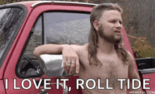 a shirtless man leaning on a red truck with a cigarette in his mouth and the words " i love it roll tide " below him