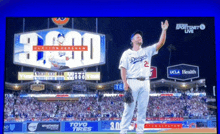 a dodgers player stands in front of a large sign that says 3000