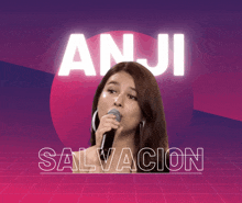 a woman singing into a microphone with the words anji salvacion behind her